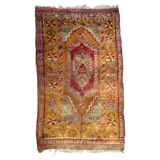 Antique Turkish Anatolian wool rug with ochre stepped medallions and a mustard border