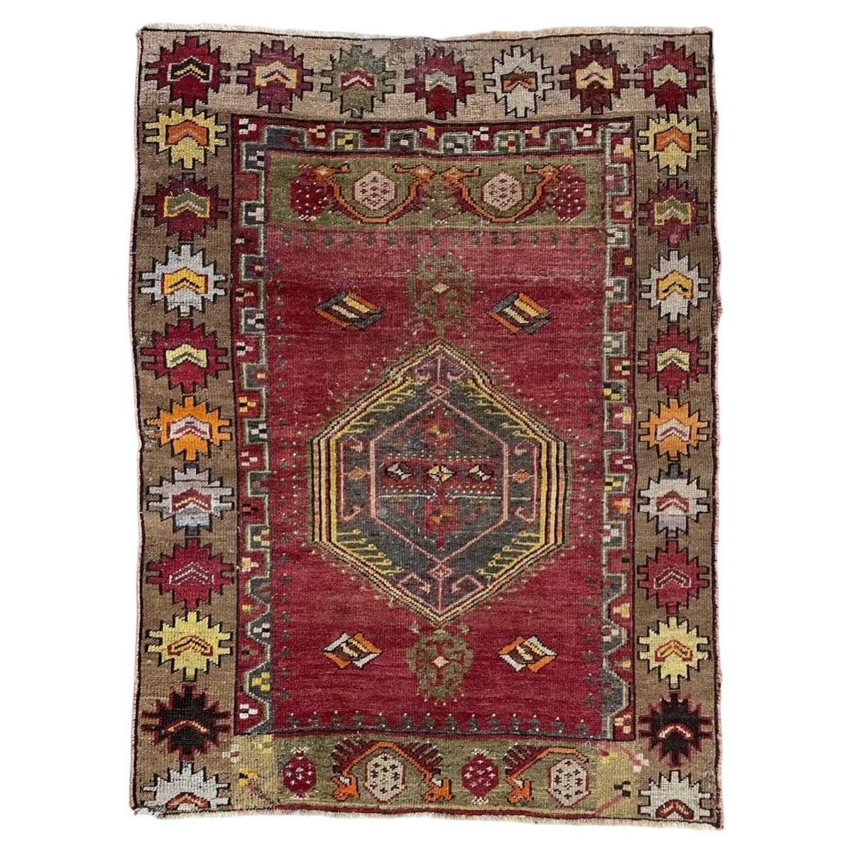 Full Turkish Anatolian wool rug with red field, dark hexagonal medallion and taupe geometric border.