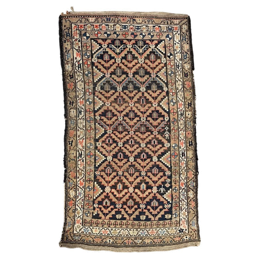 Full vintage wool rug with navy floral lattice and layered ivory and taupe borders.