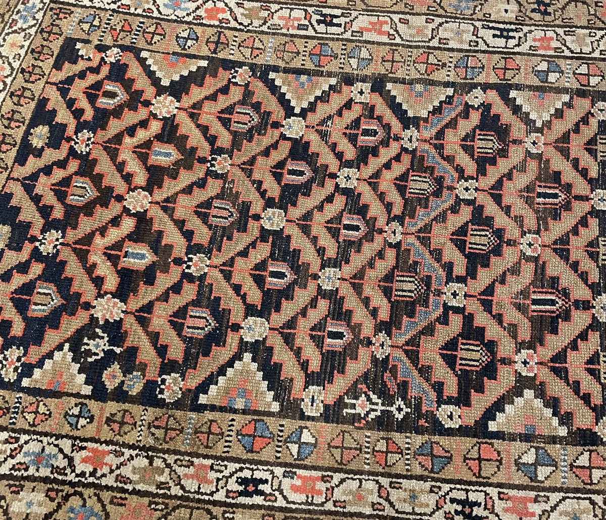Navy lattice field with coral-outlined leaves and loose threads along the side.