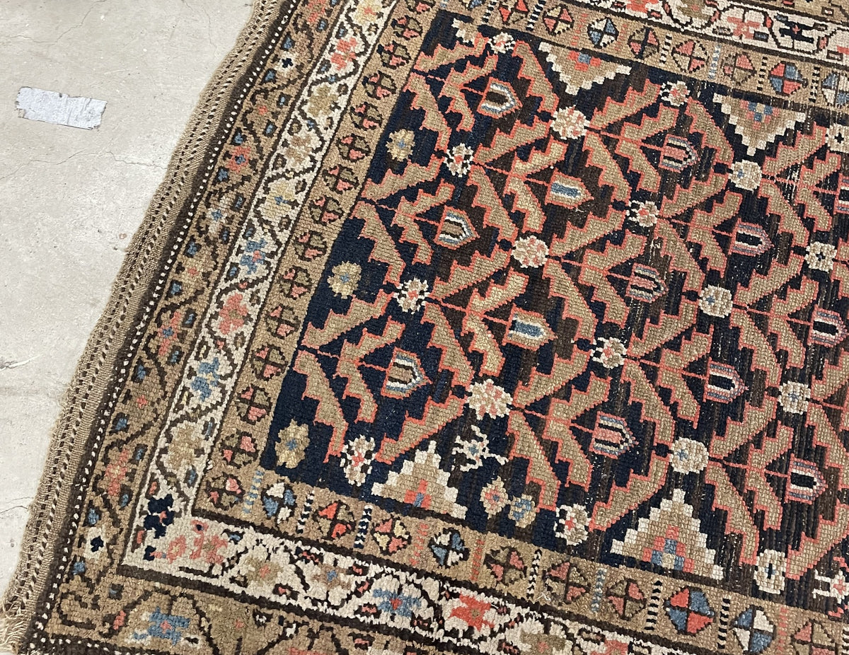 Folded rug corner revealing the reverse weave and short fringe remnants.