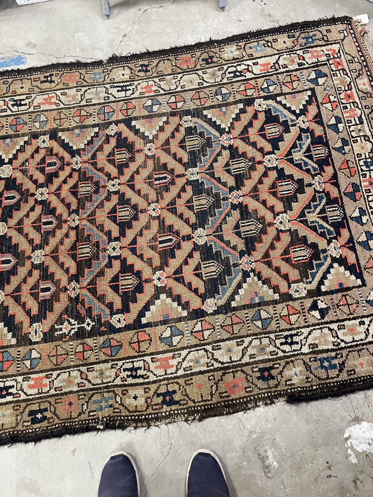 Overhead detail of the navy floral lattice and light scrolling borders.