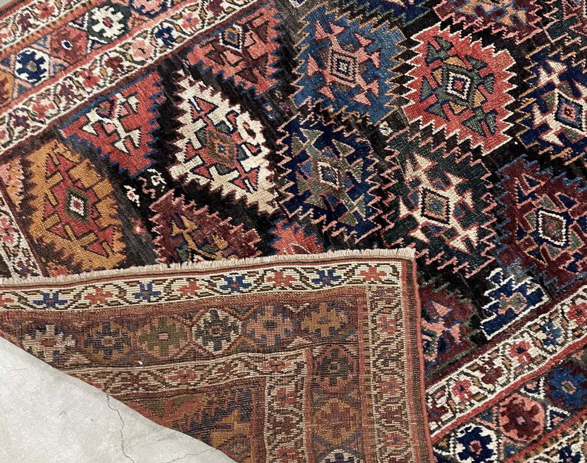 Overhead detail of the all-over medallion pattern and multicoloured rosette border.