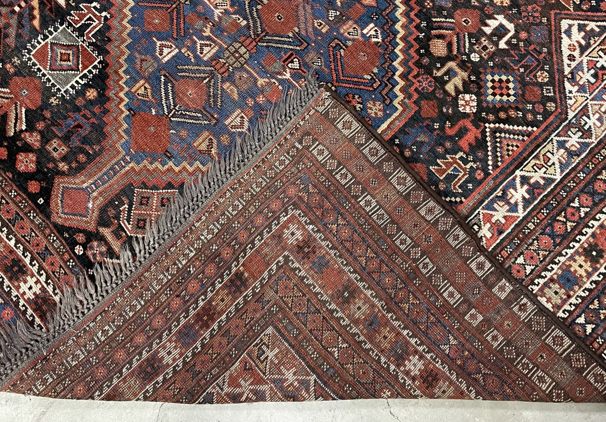 Angled field detail showing linked blue and coral medallions with birds and checkerboard diamonds.