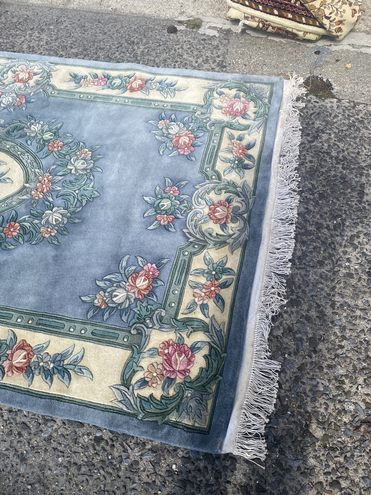 Close-up of the rug reverse showing the floral pattern and woven structure.
