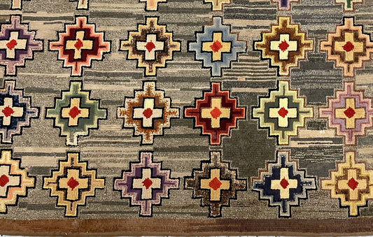 Repeated pale crosses with rust-red centres and blue, lilac, ochre and brown stepped outlines.