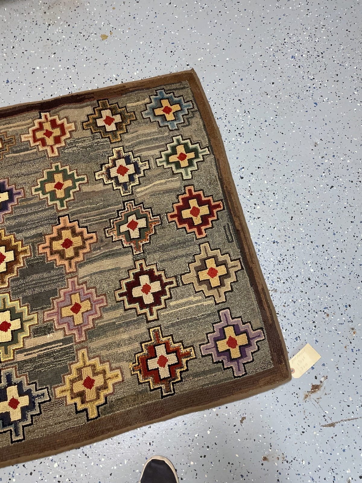 Repeating geometric medallions with dark outlines and small rust-red centres.