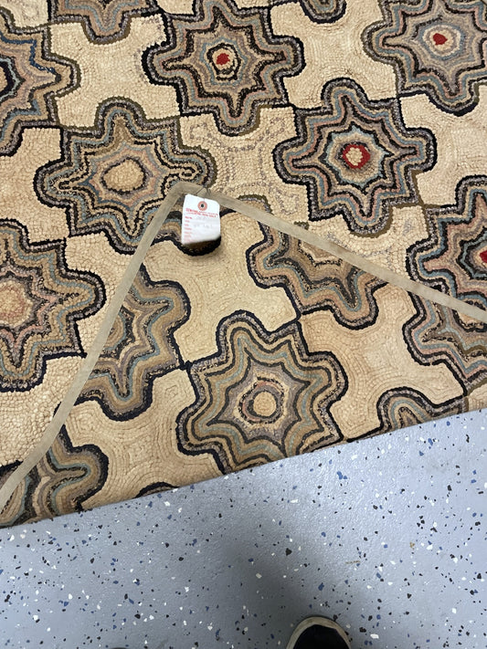 Corner detail showing cotton loops, scalloped dark outlines, localised losses and beige binding.