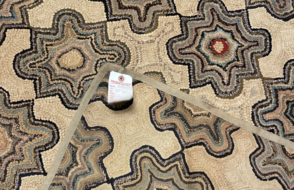 Angled view of the all-over rosette pattern with scattered brick-red centres.
