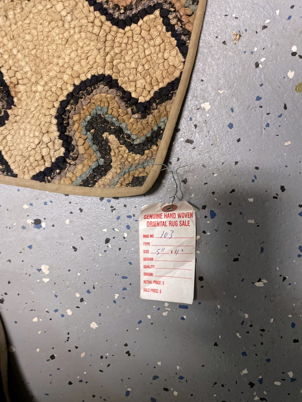 Bound corner with worn cotton loops and an attached handwritten sales tag.