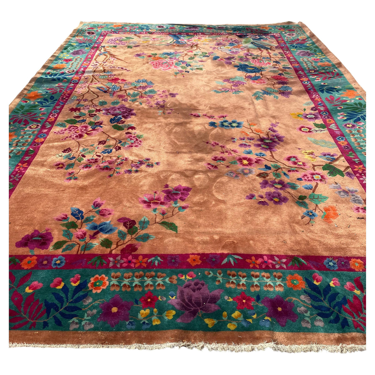 Chinese Art Deco wool rug with peach ground, colourful flowering branches and a jade-green floral border.
