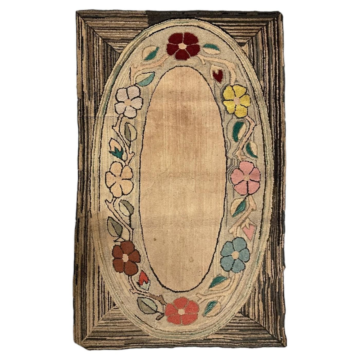 American hooked cotton rug with an open peach-beige oval, colourful floral garland and striped rectangular corners.