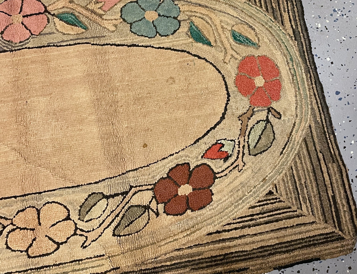 Centre detail showing small brown spots, varied cotton loops and pink and dusty blue flowers.