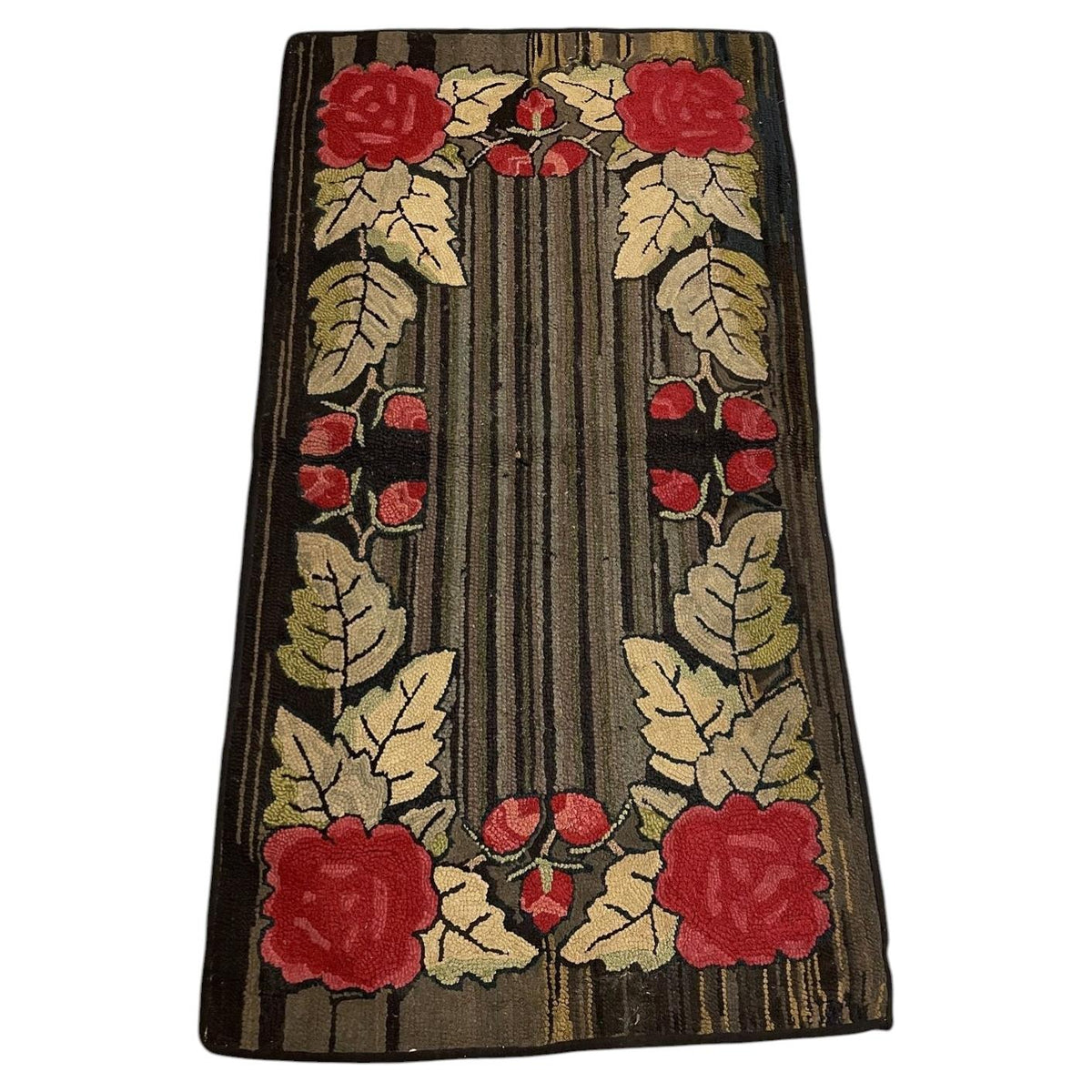 Full American hooked wool rug with four red roses, cream leaves and a lengthwise striped brown and charcoal centre.