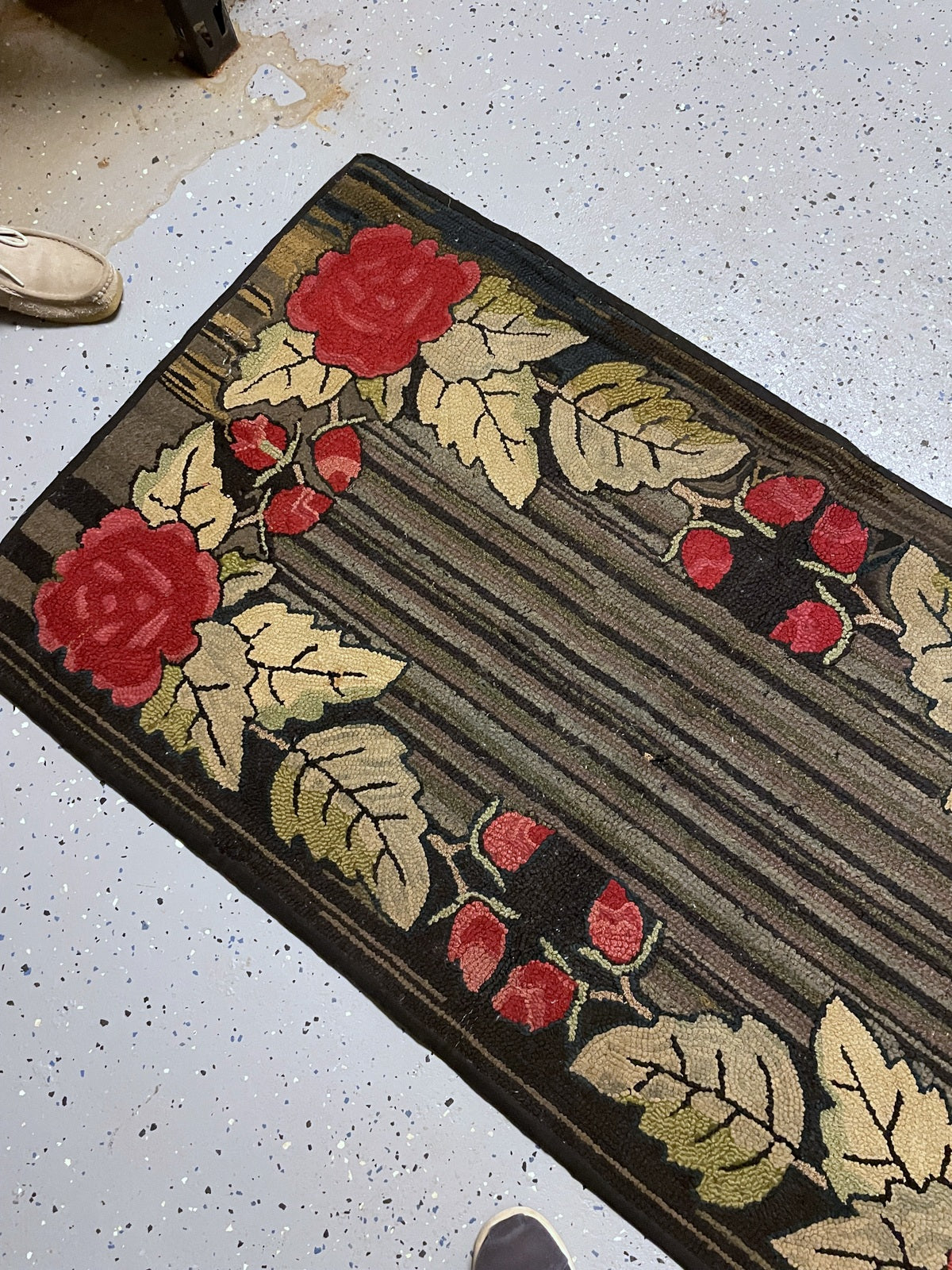 Angled view of red roses and pale leaves surrounding the narrow striped field.