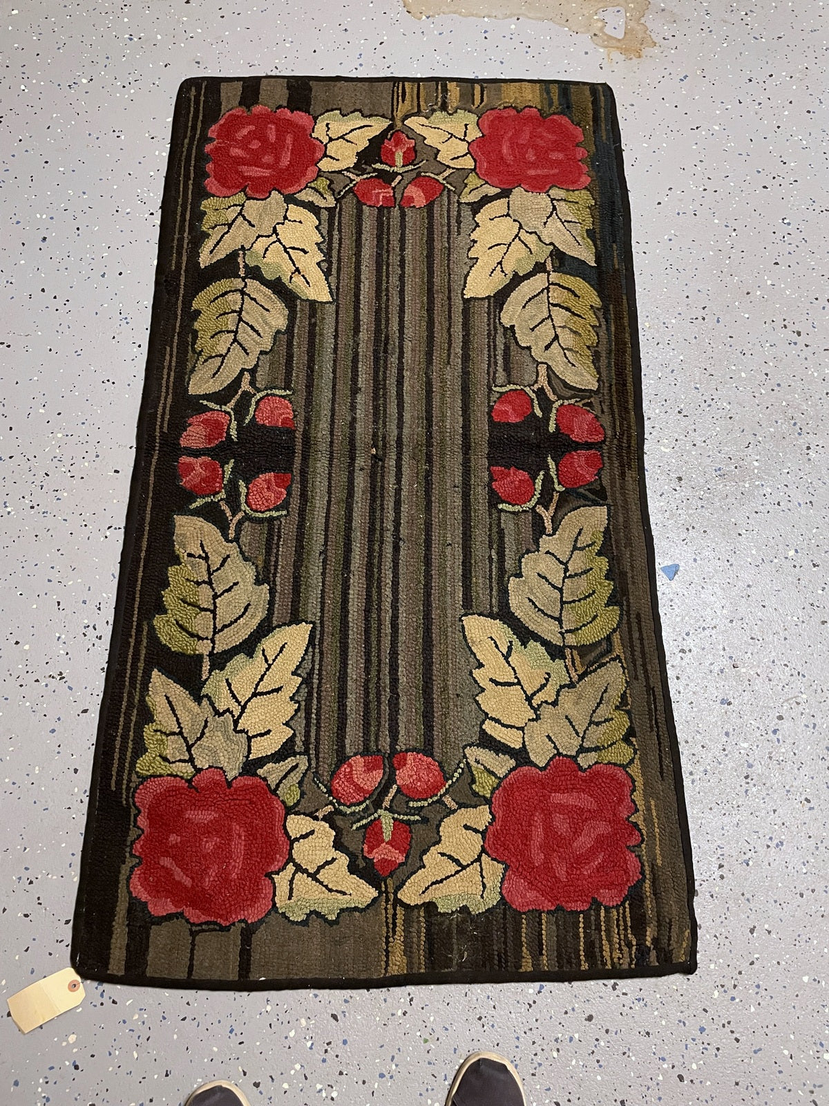 Full-length rectangular rug showing four red corner roses and symmetrical leafy stems around the striped centre.