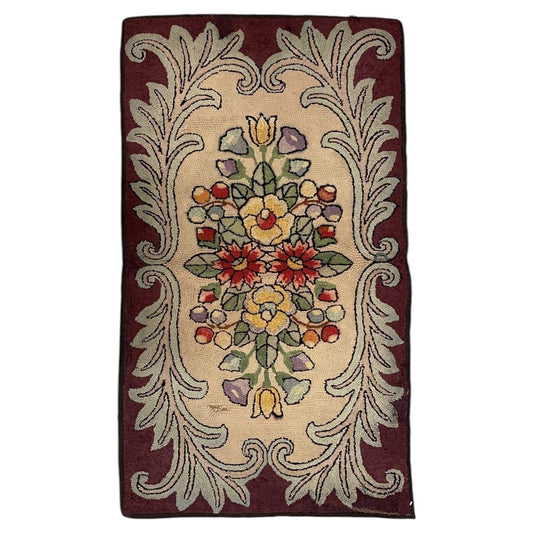 Full American hooked wool rug with mirrored colourful flowers on cream, pale sage acanthus scrolls and a burgundy border.