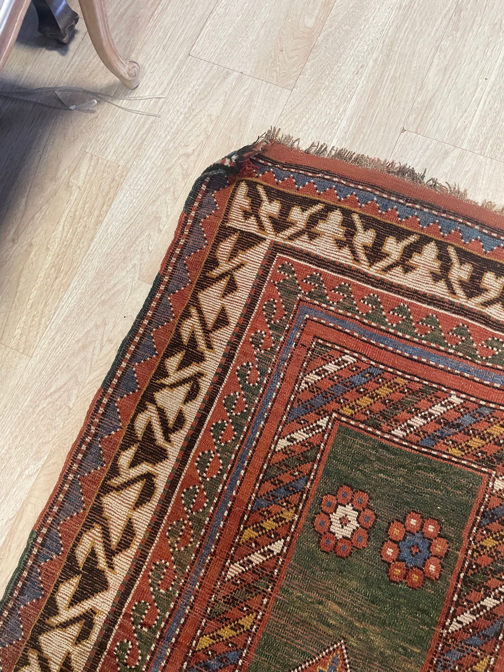 Well-preserved 1860s Borchalu Kazak rug featuring bold tribal geometry, stylized flowers, and a time-worn border section.


