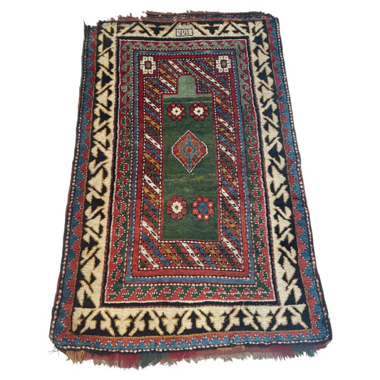 Antique 1860s Caucasian Borchalu Kazak rug, 4.1 x 6.2 feet, featuring a vibrant green field with tribal geometric motifs.

