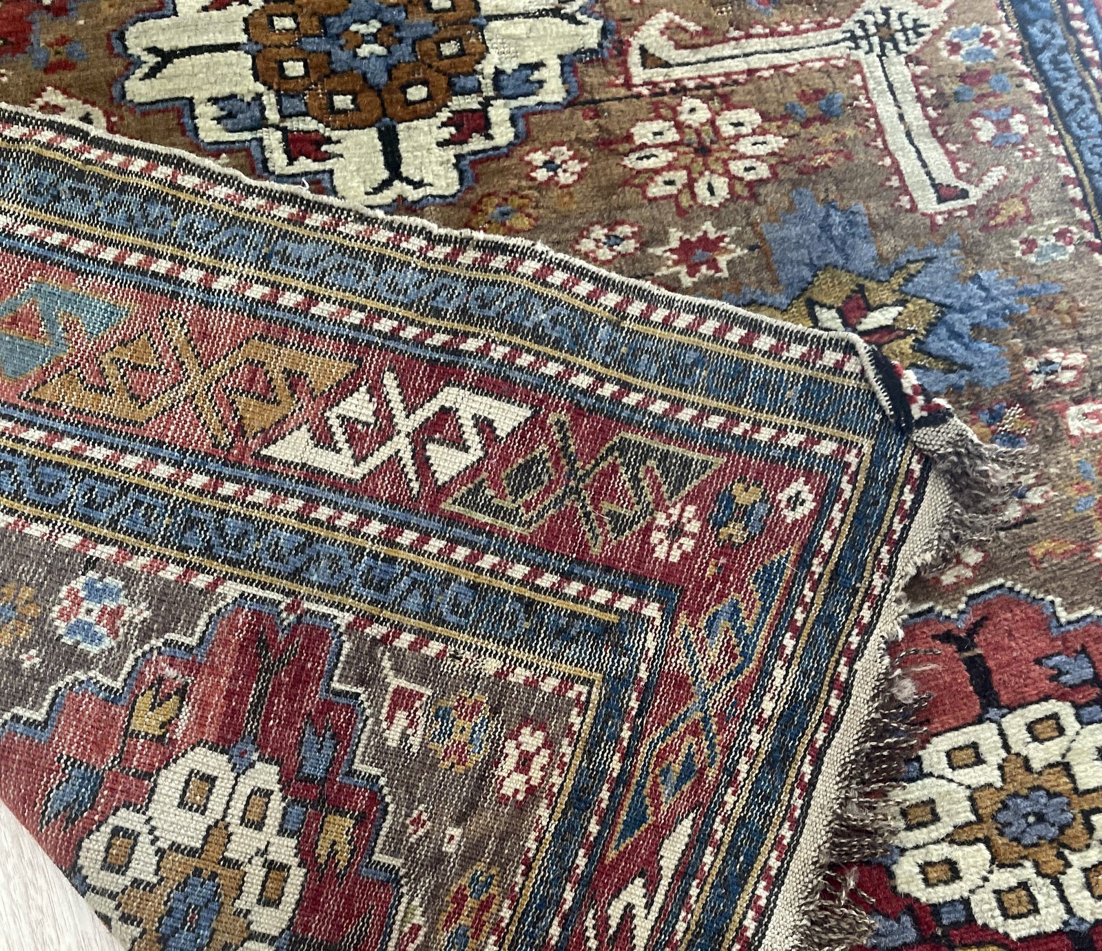 Antique Caucasian carpet ideal for library or study in interior setting with rich vegetable dyes

