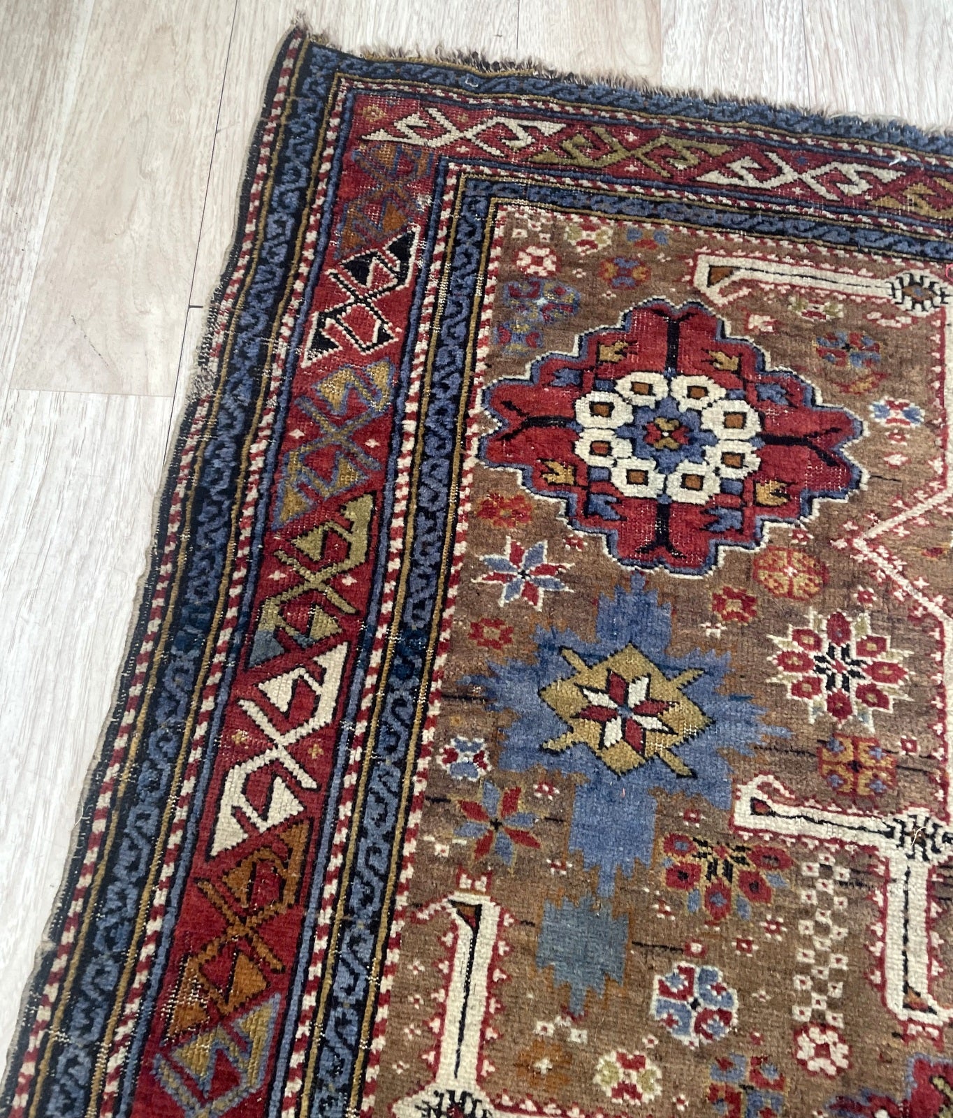 Handmade Kuba rug Caucasus circa 1880s with tobacco brown madder red ivory and indigo colors


