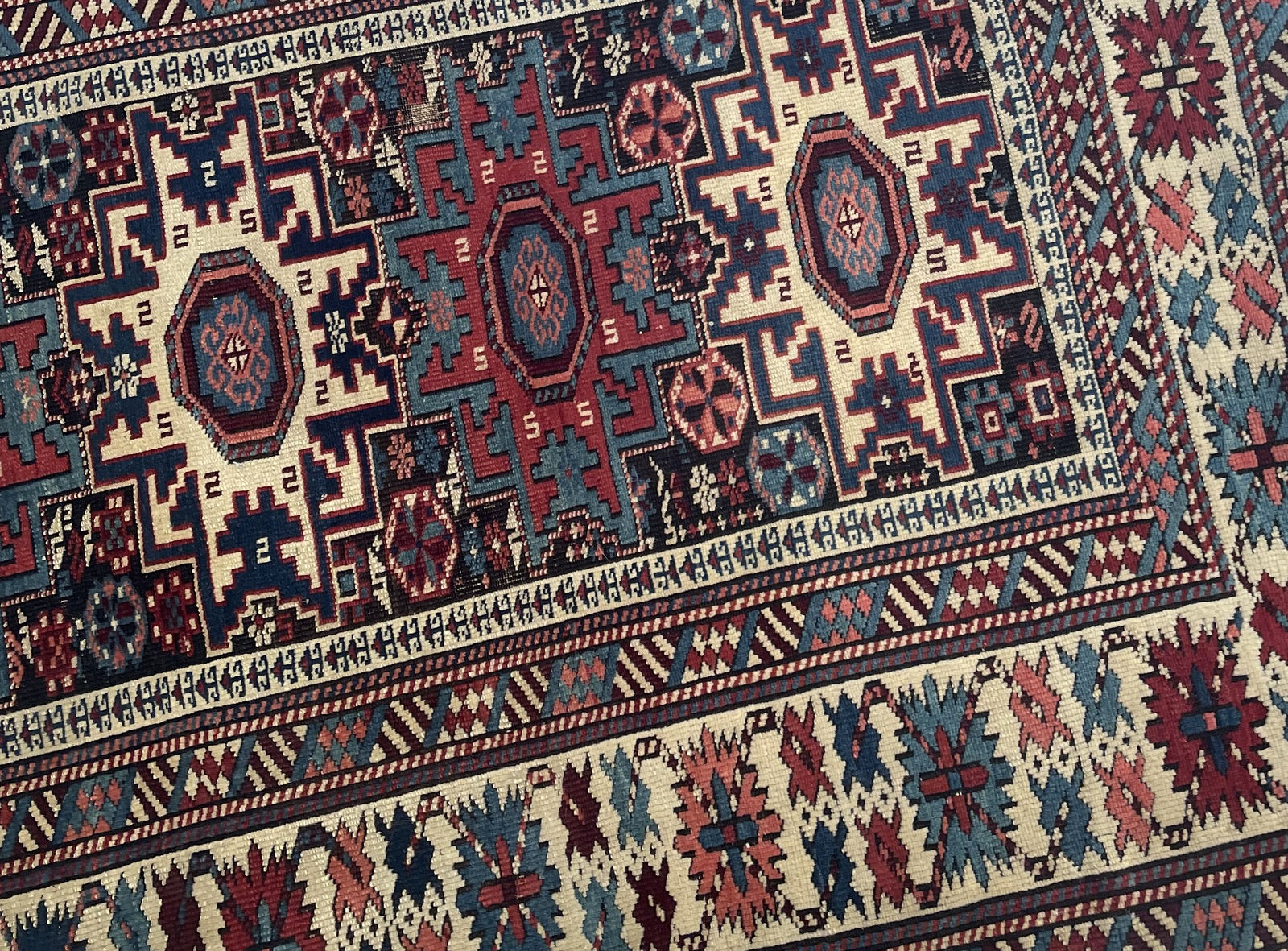Handmade Lezgi rug Caucasus circa 1880s with deep indigo madder red ivory and ochre colors

