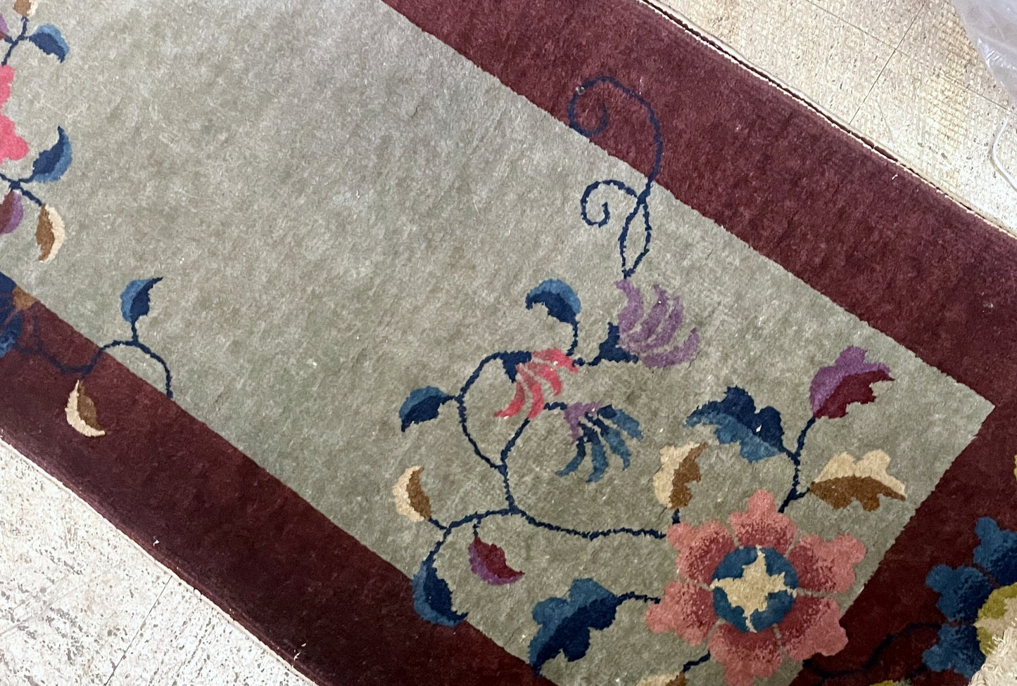 Handmade Chinese rug circa 1920s with celadon green oxblood red peony pink and indigo colors

