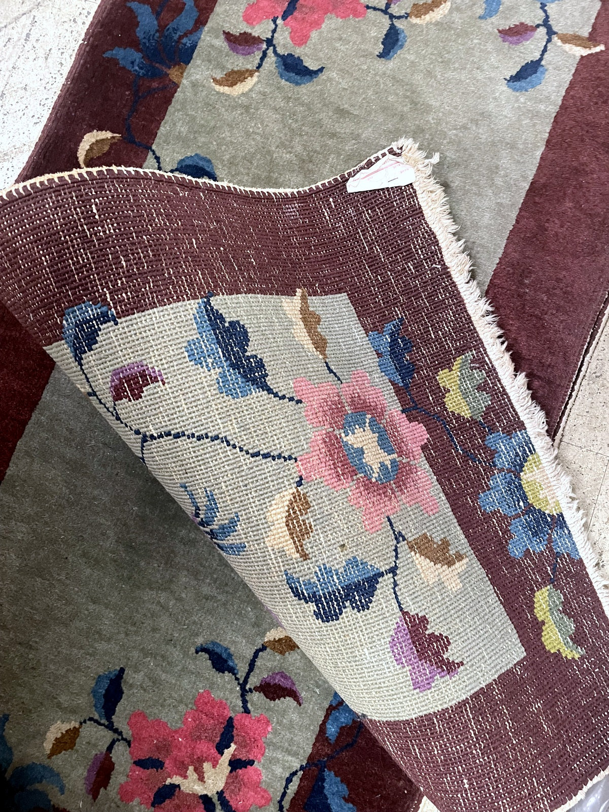 Small antique rug ideal for entryway bedside accent or sophisticated wall hanging in interior setting

