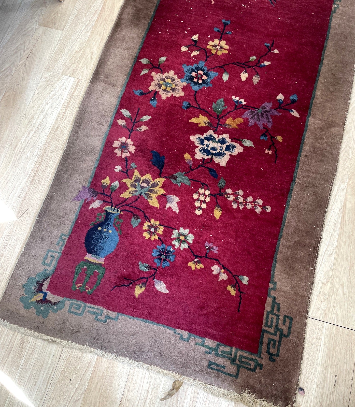Vintage Chinese rug from Tientsin region with navy blue scholar's vase and bird motifs on floor

