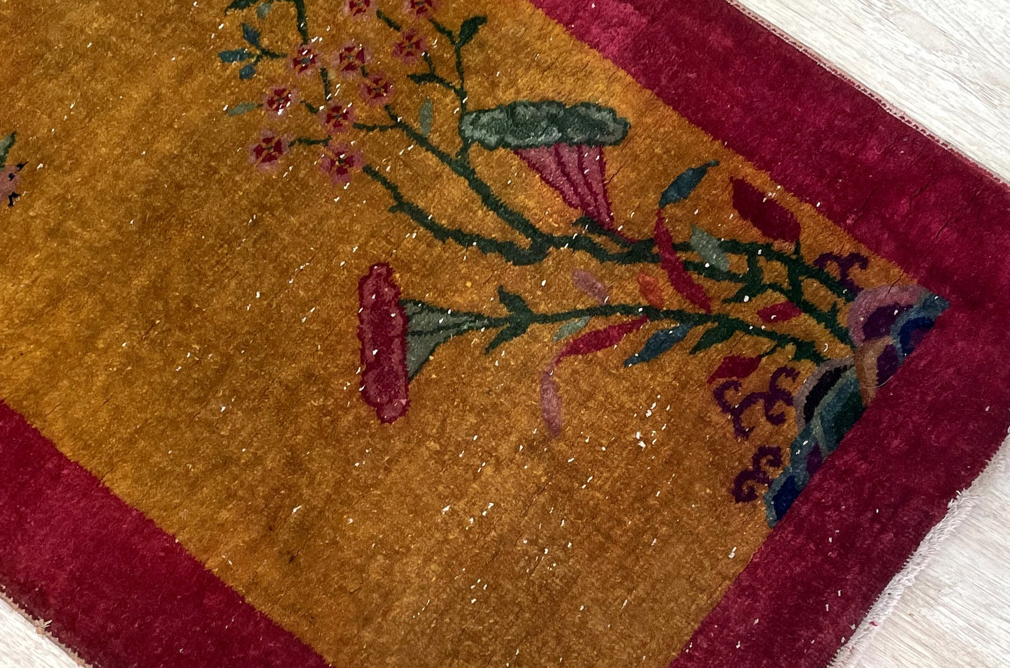 Antique Chinese carpet with golden ochre crimson red forest green and plum color palette

