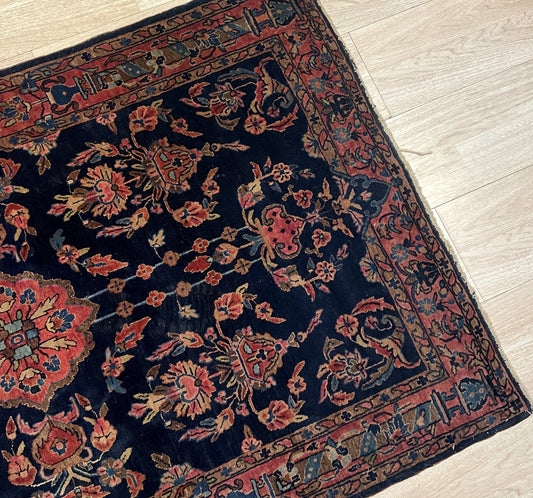 Early 20th century Persian Mahajiran rug with central medallion and dusty rose floral sprays on floor

