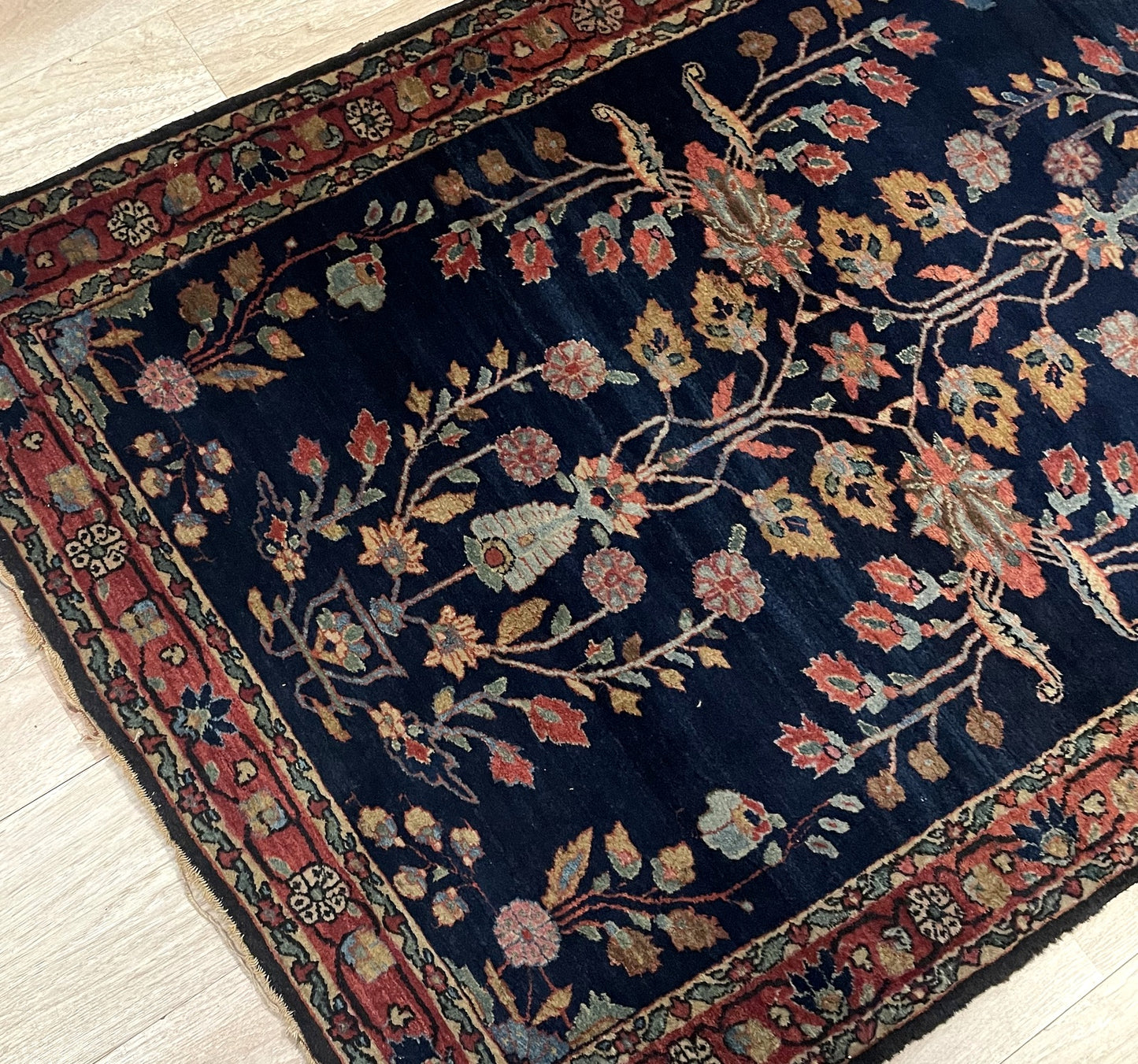 Corner detail showing fine weave and balanced floral arrangement on 1900s Persian rug