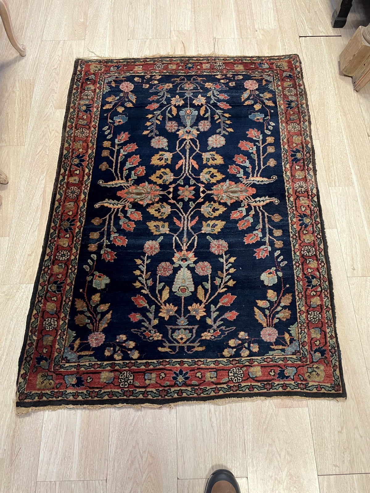 Classic midnight-blue ground accented by sophisticated "sprig" or floral-spray Mahajiran design