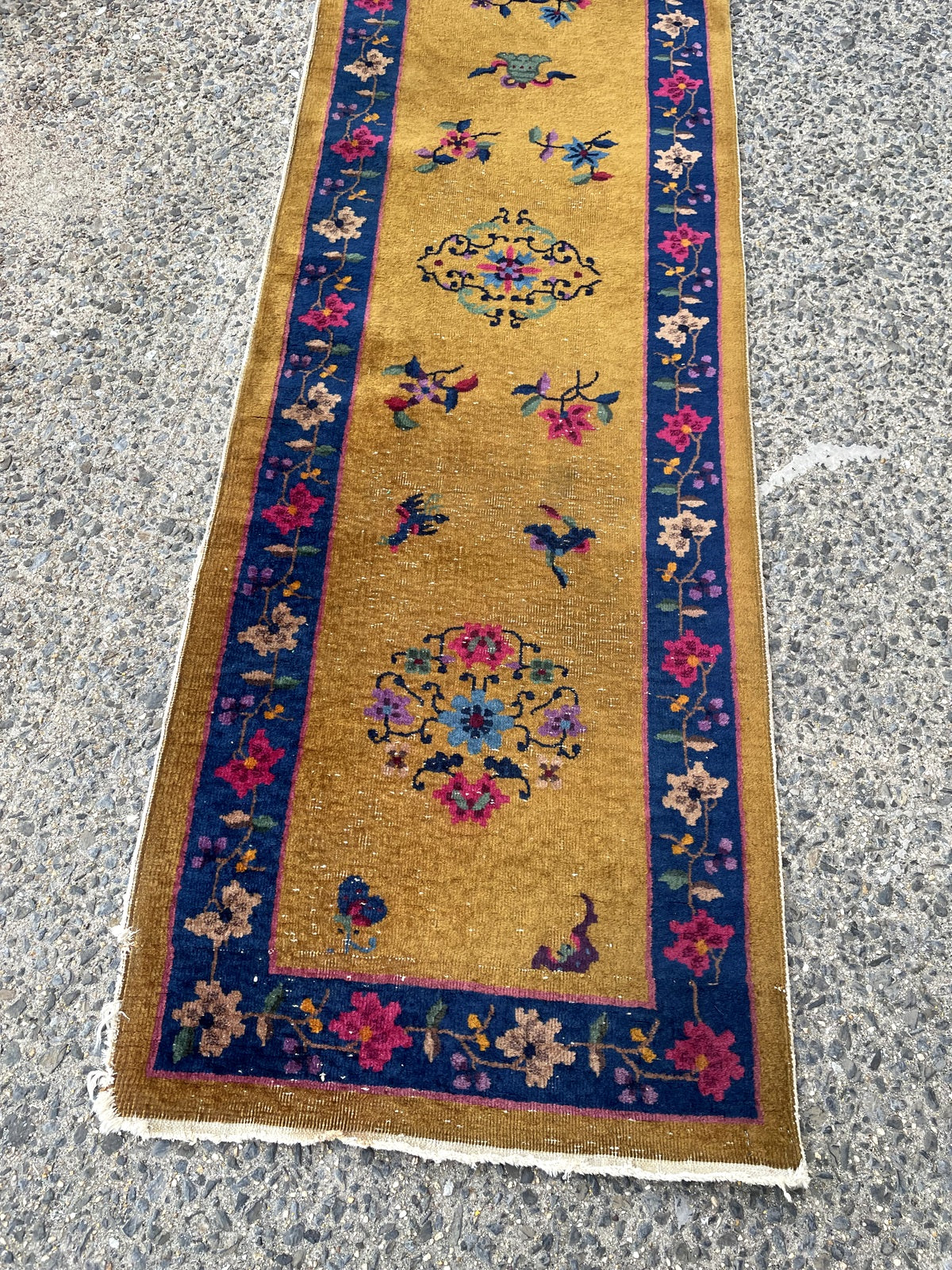 Rich golden ochre field decorated with sparse elegant floral sprays butterflies and Endless Knot motifs