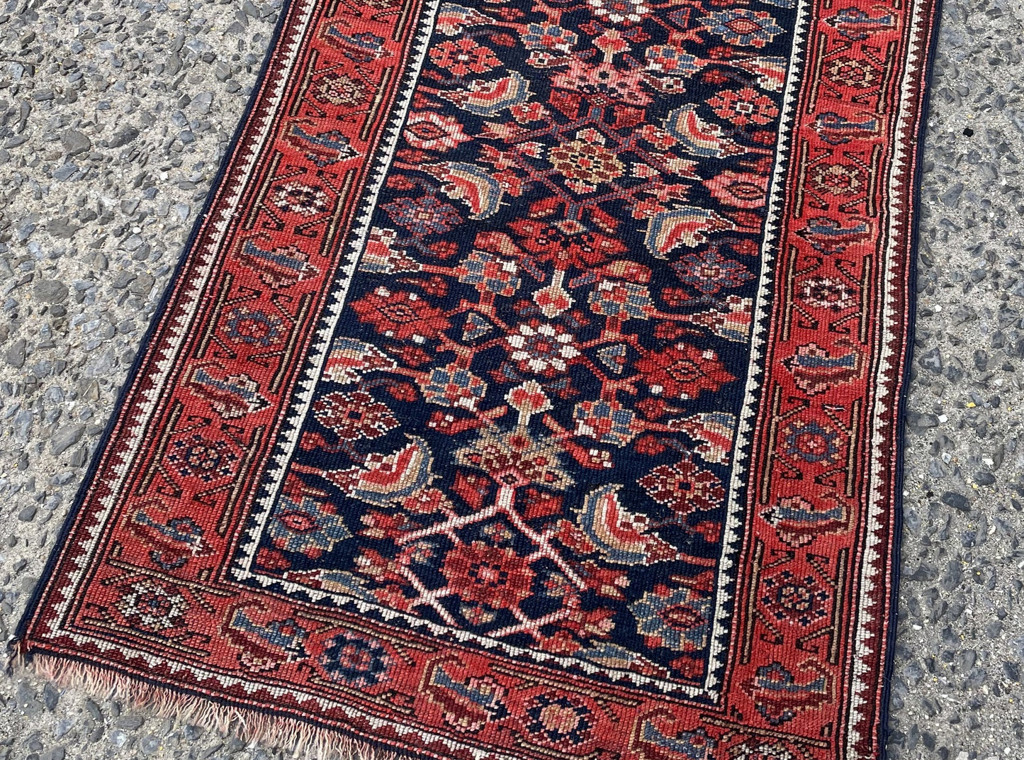 Close-up of antique Kurdish runner displaying high-contrast rhythmic geometric patterns and Mina Khani motifs

