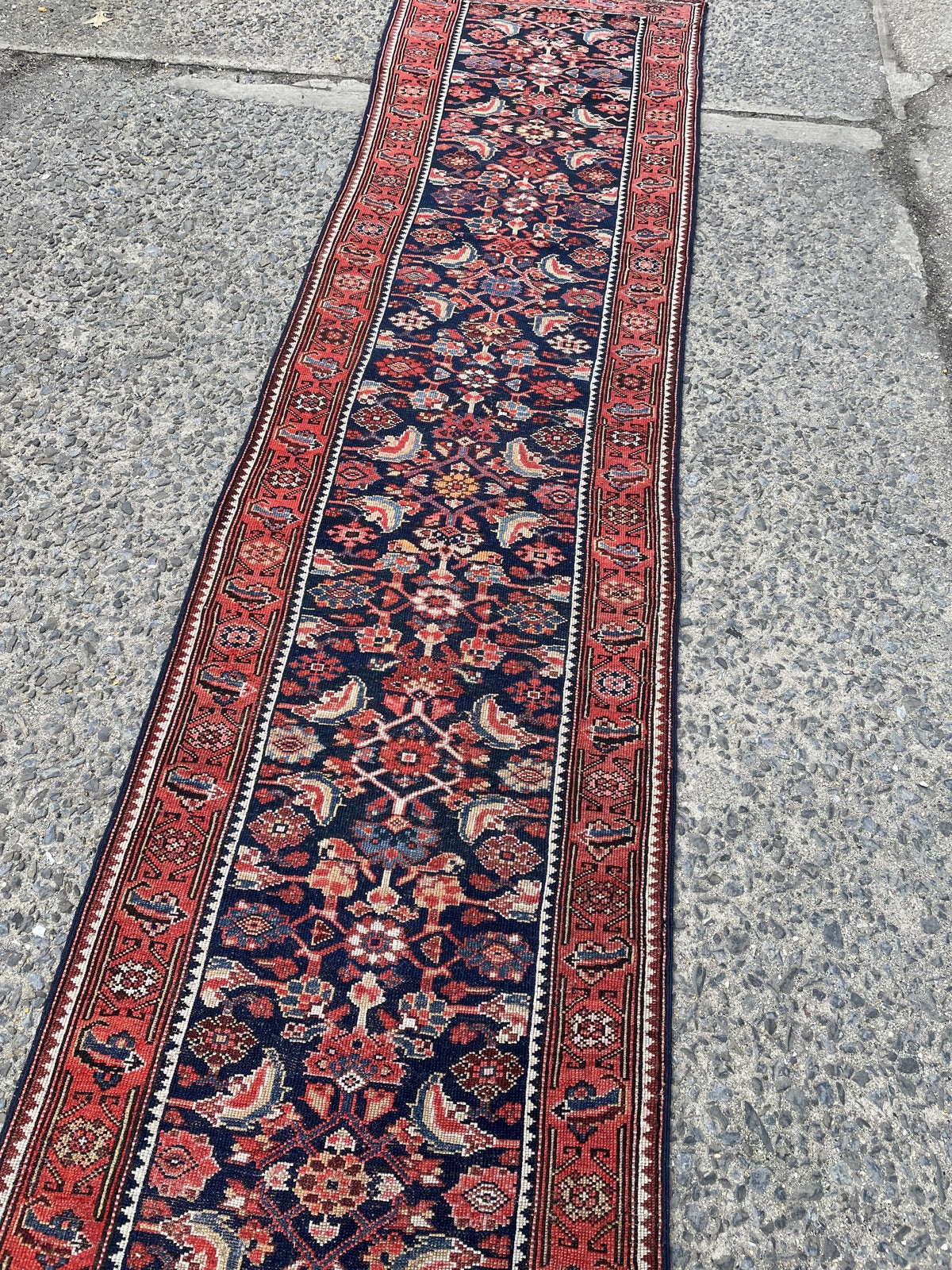 Close-up of traditional repeating "S" motif and geometric rosettes on wide architectural border