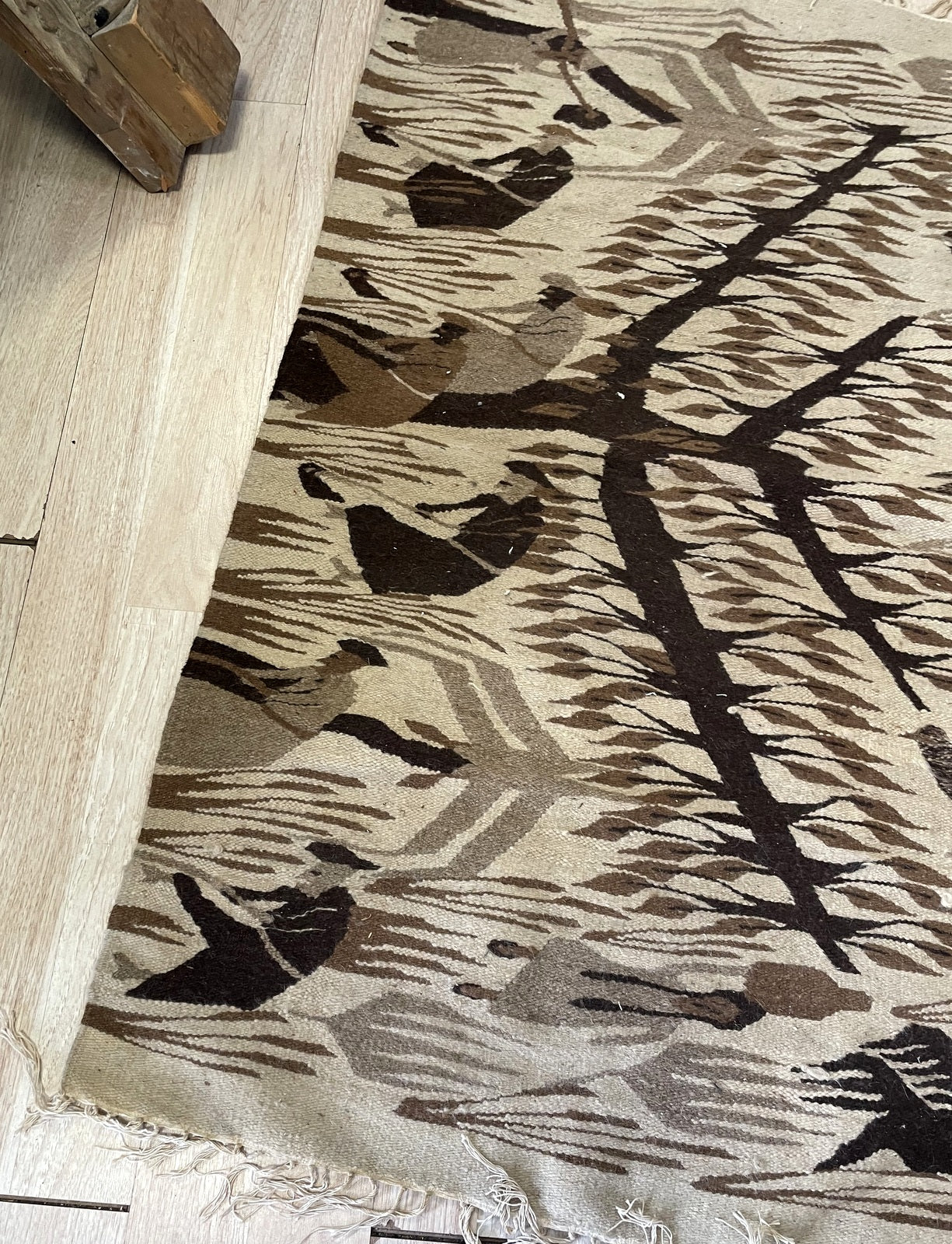 Close-up of vintage Zapotec Kilim showcasing complex centered medallion and Greca fretwork borders

