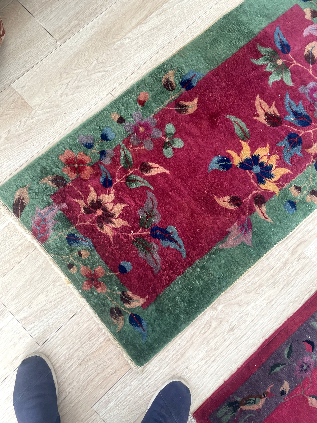 Vintage Nichols style rug from China with deep violet-purple ground and asymmetrical floral design on floor

