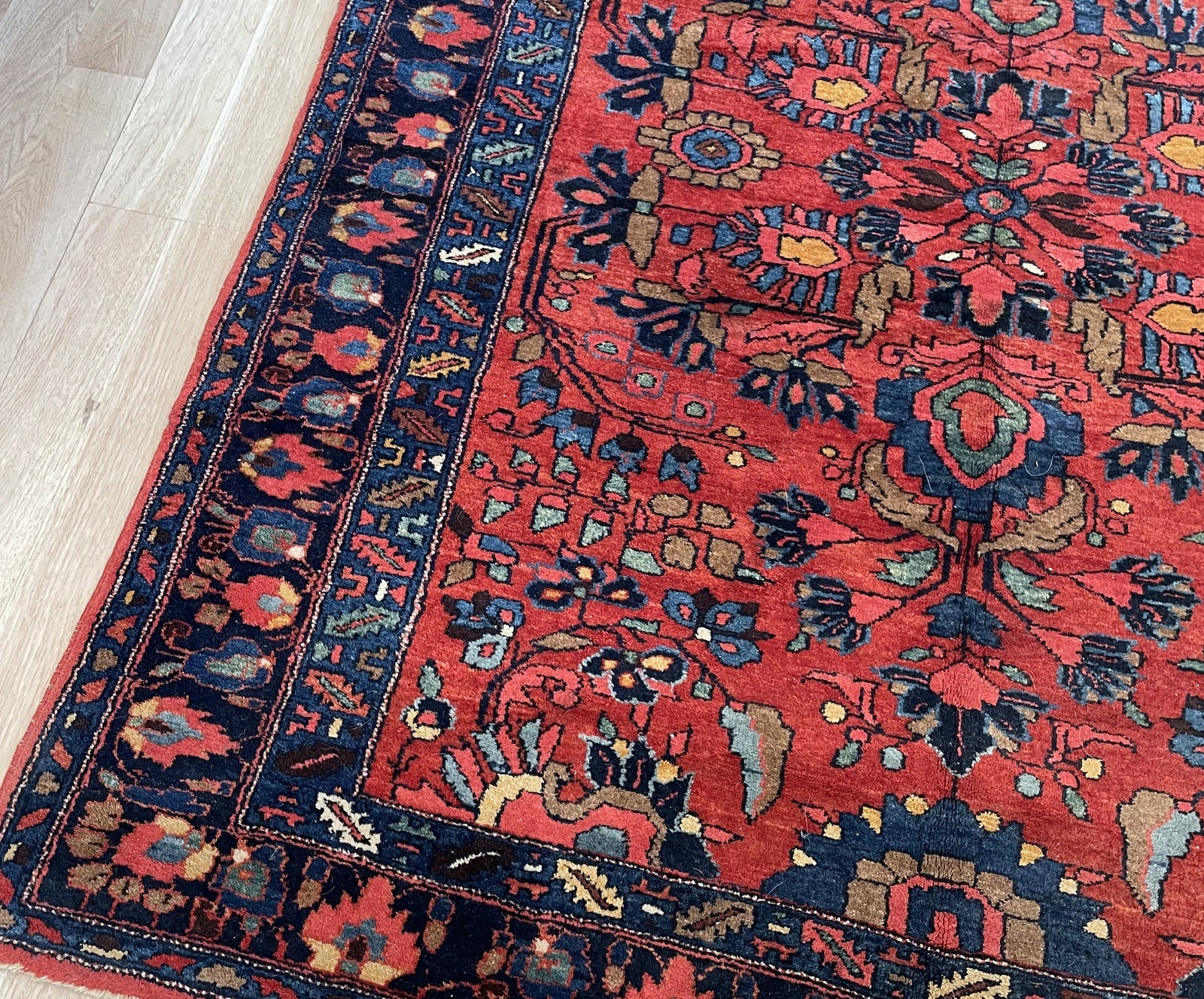 Early 20th century Armenian-Persian village rug from Hamadan region with soft earthy salmon-pink ground on floor

