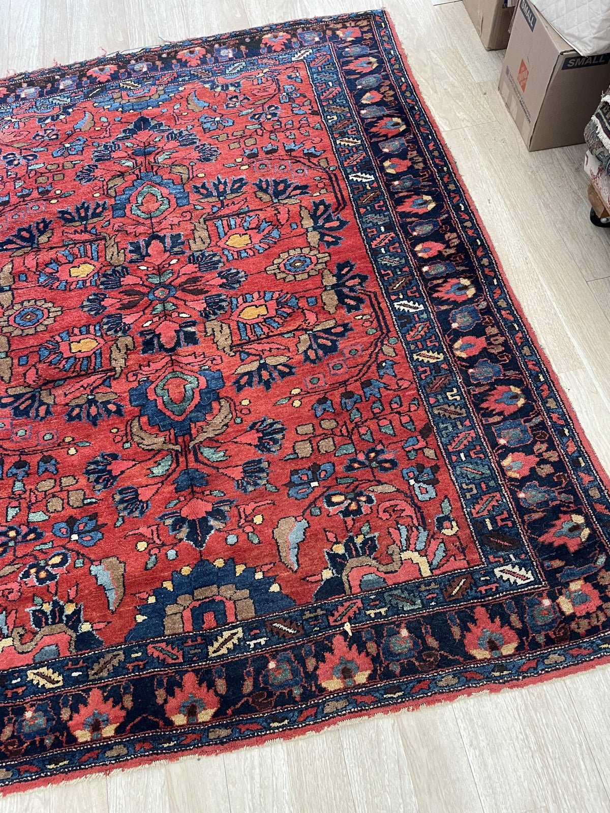 Close-up of antique Lilihan rug showcasing delicate floral medallion and curvilinear floral sprays with palmettes

