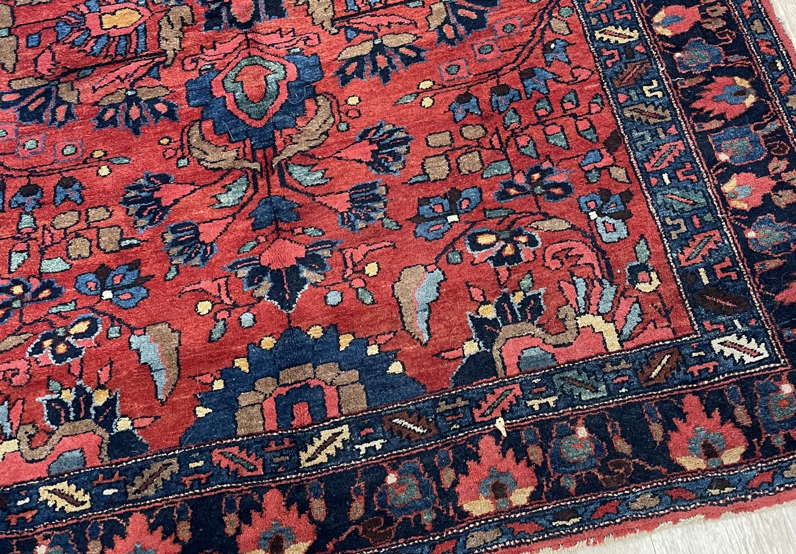 Nearly-square antique rug ideal for breakfast nook home office or bedroom in interior setting

