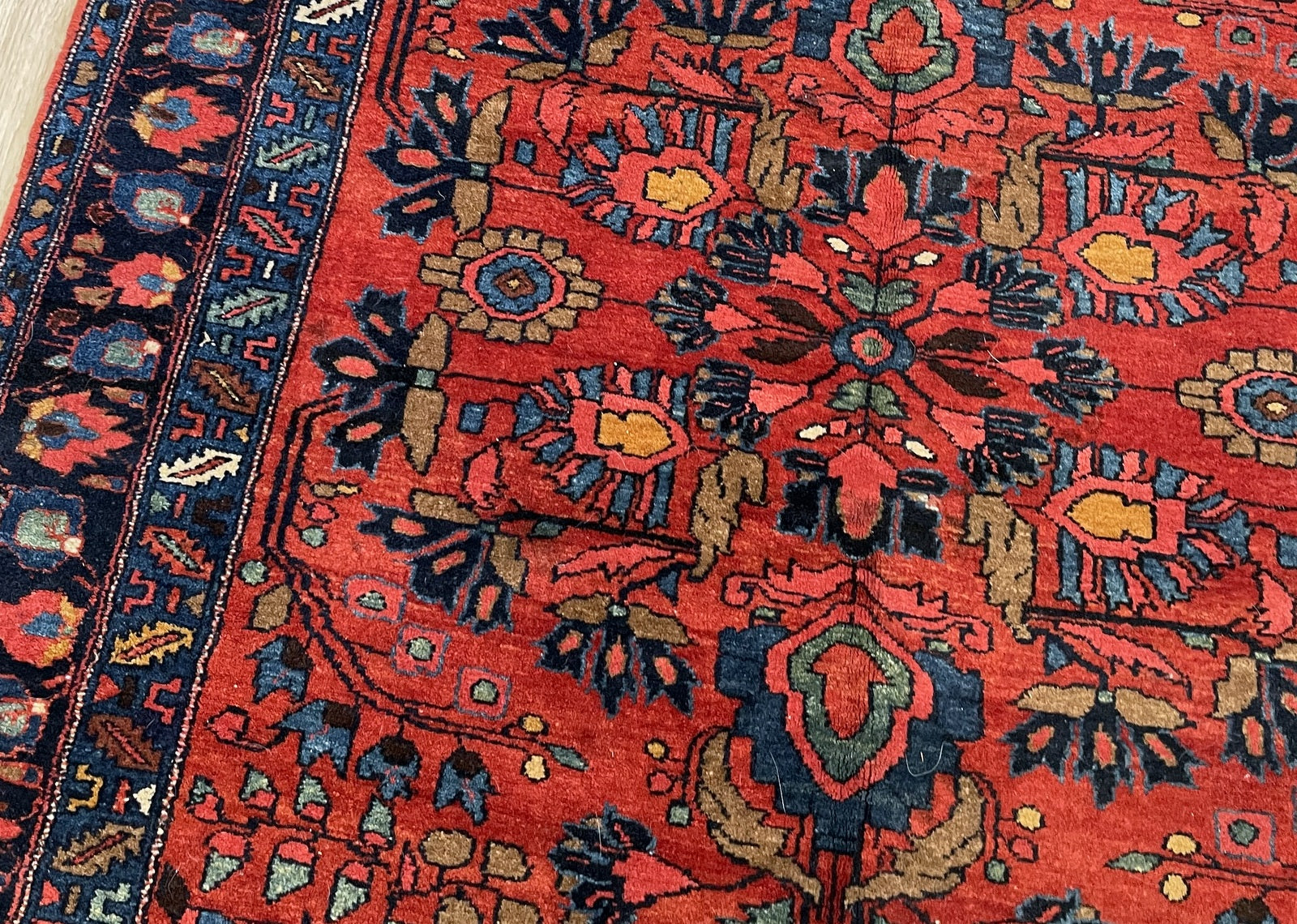 Close-up of delicate floral medallion surrounded by curvilinear floral sprays and palmettes