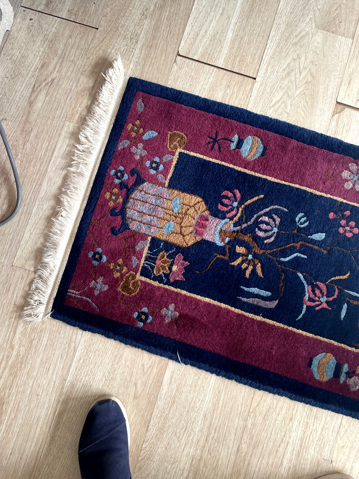 Deep eggplant midnight navy wool pile of antique Chinese Art Deco rug with coral rose and gold floral accents