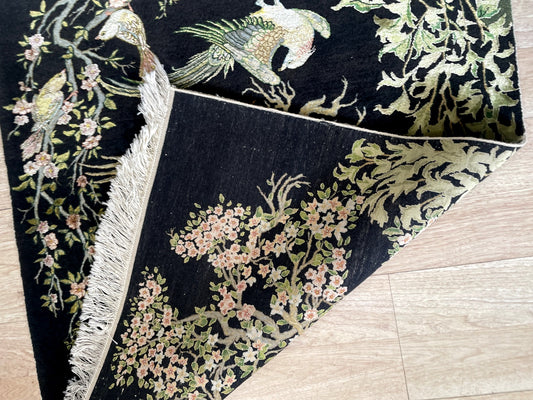 Fine silk-on-silk Tabriz rug from Iran with deep crimson and royal blue jewel tones on floor

