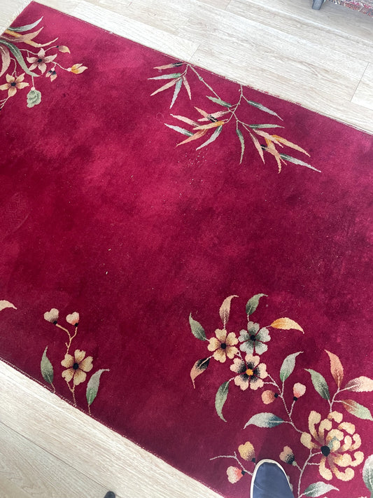 Vintage Nichols style Chinese rug with brilliant gold magenta or teal field and floating floral motifs on floor

