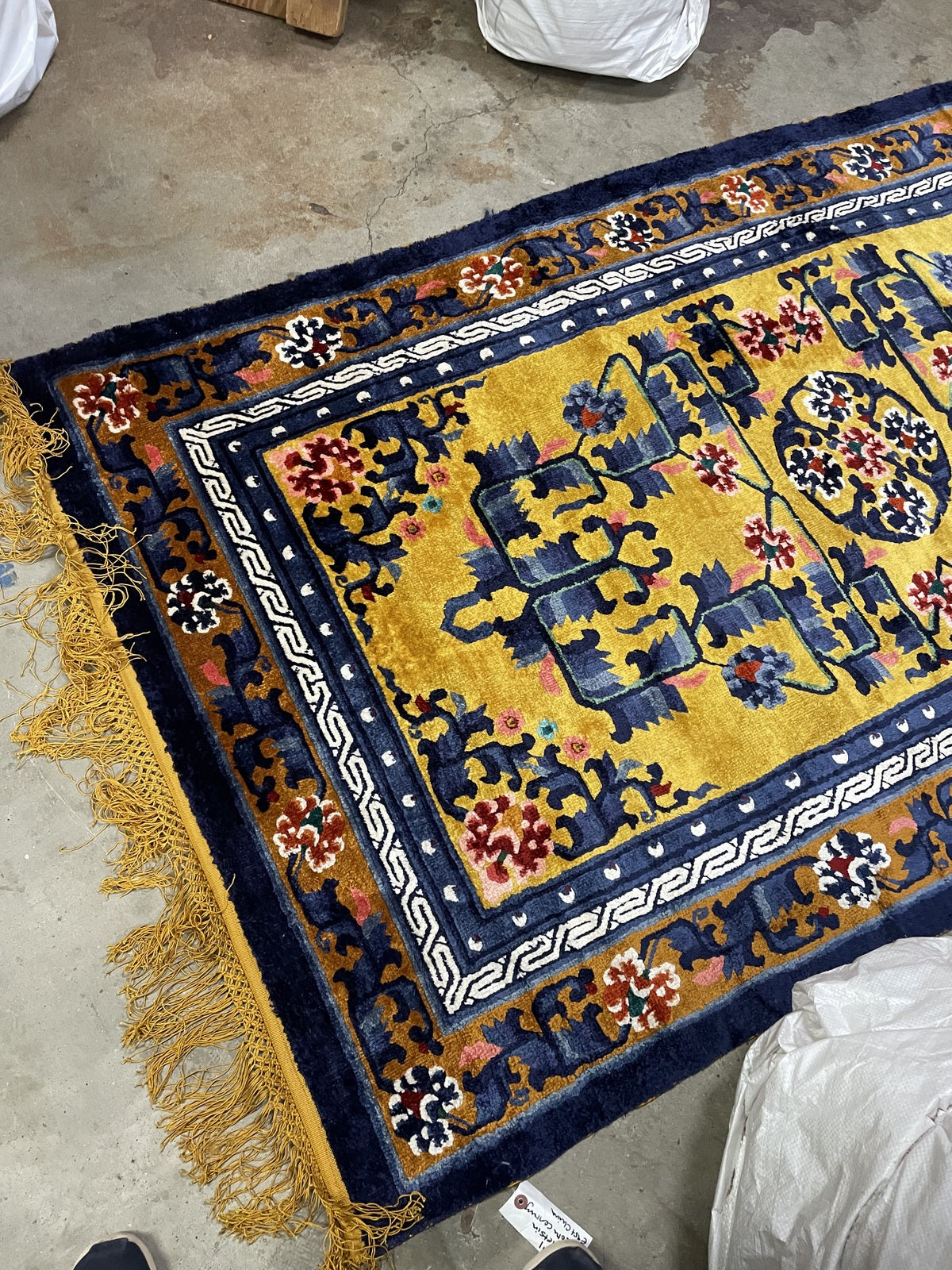 Vintage Chinese rug corner detail, showcasing craftsmanship and silk texture