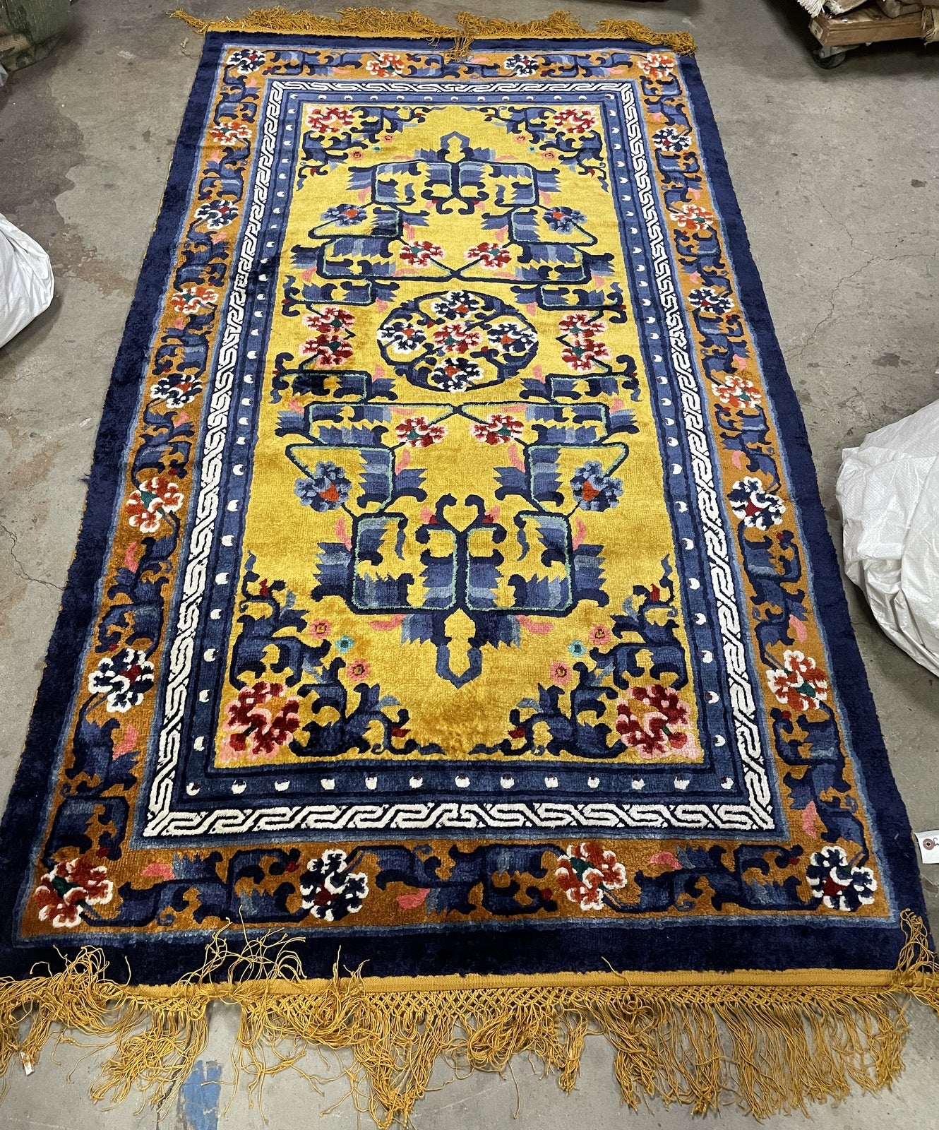 Handmade Chinese silk rug, golden field with deep blue border contrast