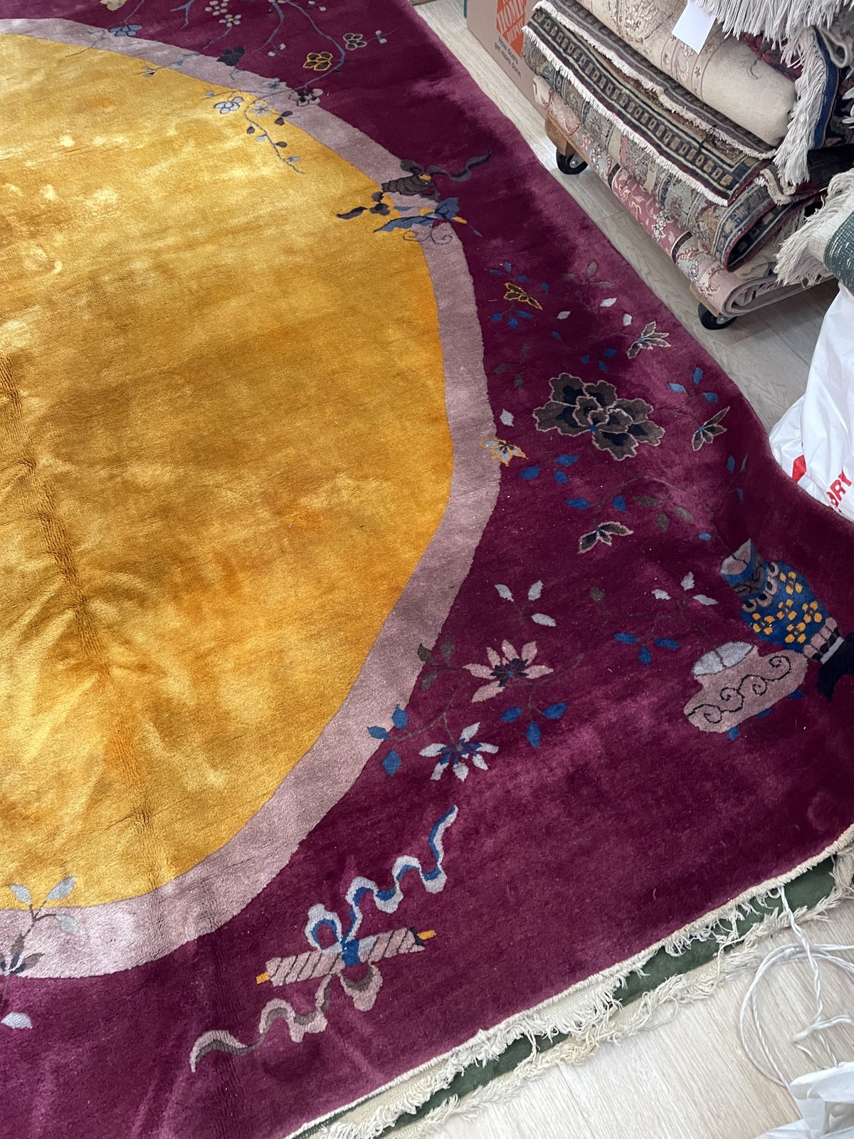 Full perspective of an antique Art Deco Chinese carpet displayed in a formal setting, demonstrating its 8'1" x 10'2" size suitable for a living room, dining room, or master suite.

