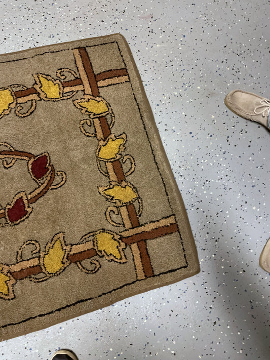 Corner detail showing yellow leaves, crossing brown and cream bands and taupe binding.