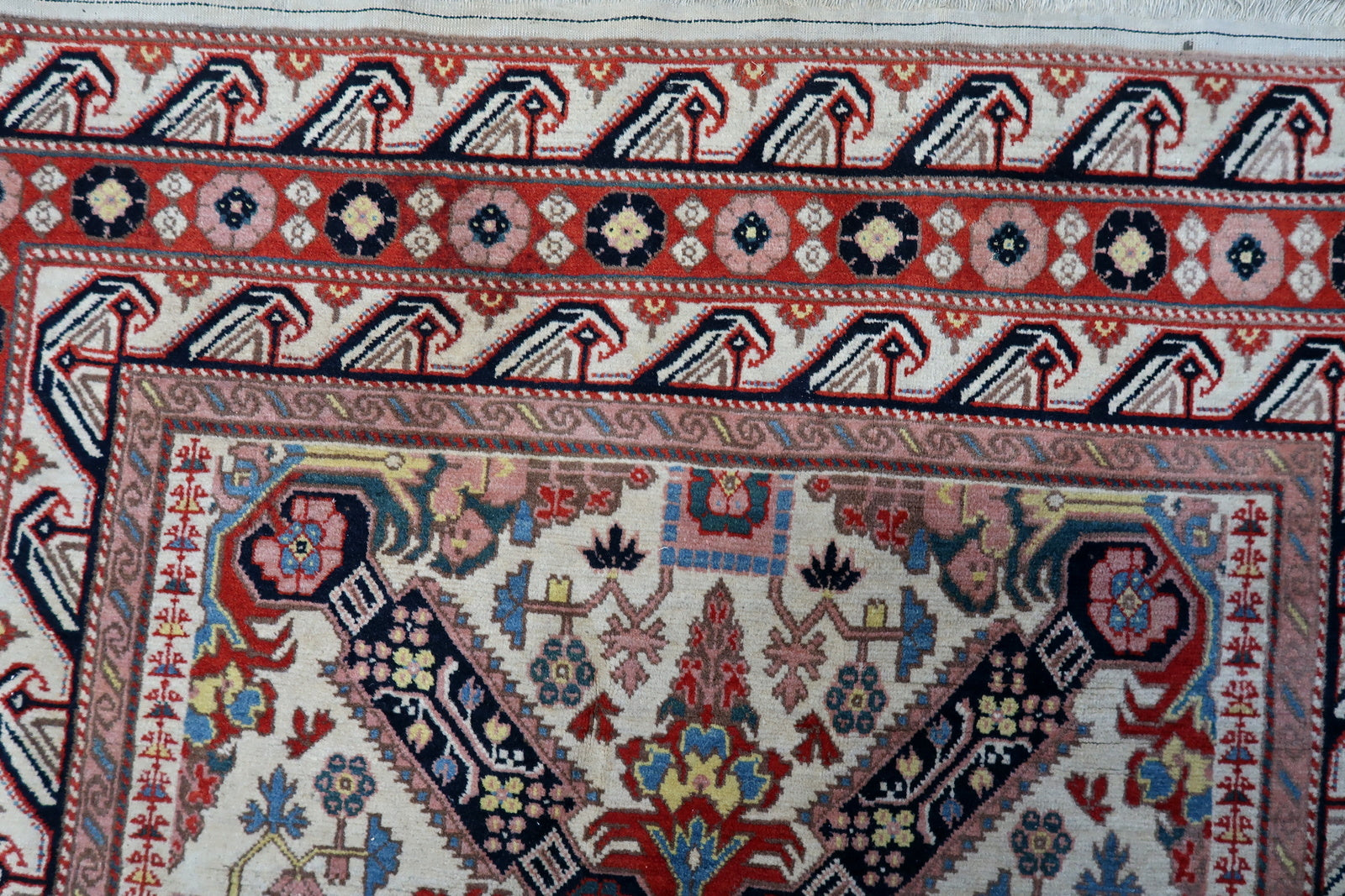 Detailed view of the soft wool texture and vibrant red accents on the rug